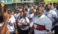 Hon Kwadwo Baah Agyemang walking with a thick crowd to file his nomination papers