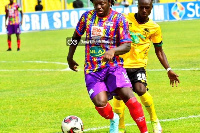 Hearts' Sulley Muntari pulls away from a Kotoko player