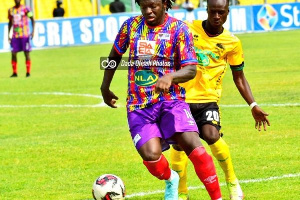 Hearts' Sulley Muntari pulls away from a Kotoko player