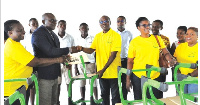 Dr Kenneth Agbodza (middle) presented 100 tables and chairs worth GH¢140,000 to the school