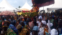 Nene Tetteh Zogli II riding in a palanquin being cheered on by the people