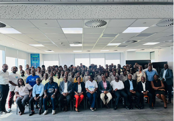 Staff of Standard Chartered in a photograph with the adolescent boys