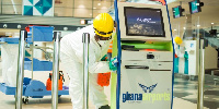 One of the cleaning team disinfecting an equipment at the airport