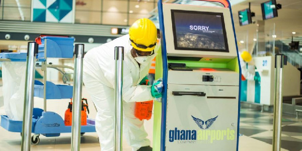 One of the cleaning team disinfecting an equipment at the airport