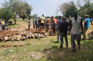 People of Kandiga using their hands to rehabilitate deplorable road