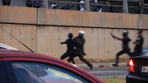 The Police rounding up on an alleged protester to assault him