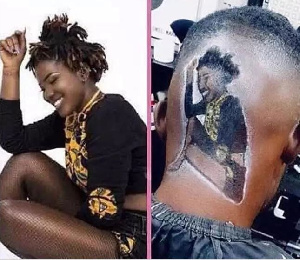 The male fan captured sitting at a barber shop with an Ebony image inked on his head