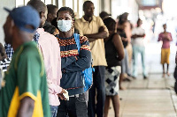 People queue at money transfer service in Bulawayo, Zimbabwe, ZINYANGE AUNTONY | AFP