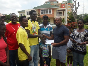 George Darko (Left) receiving his cheque from McCauley