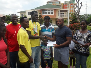 George Darko (Left) receiving his cheque from McCauley