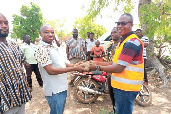 Mr. Daniel Kwame Gariba (right) handing over a site to one of the contractors