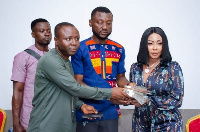 CCF boss, Ibrahim Oppong Kwarteng and Linda Owusu presenting the money to management