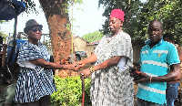 Mr. Stephen Gebuti handing the seedlings to the Navro-Pio