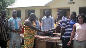 HRM Awulae Attibrukusu III in cloth presenting the items to the headmaster of the school