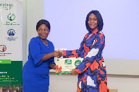 Elizabeth Victoria Amanor (right) receiving the award from Databank Foundation Board Member