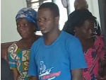 Newell Gavu (middle) being aided to court some family members