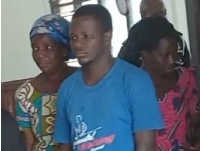 Newell Gavu (middle) being aided to court some family members