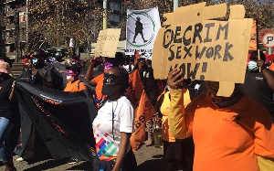 Supporters shout and sing slogans during a march in solidarity with sex workers