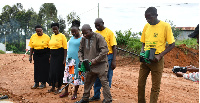 A senior Entomologist at the Ministry of Health demonstrates larviciding to the Village Health