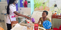 15-year-old Efua Bugyei with a child from the Korle-Bu cancer unit