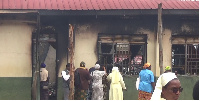 Staff and some of the members of the school's take a look inside the burnt dormitory