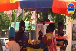 Some residents having drinks by the road side