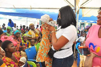 Naada Jinapor  interacting with some babies brought for the medical outreach