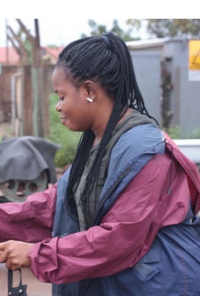 Millicent Aheto sells fuel at a mechanic shop