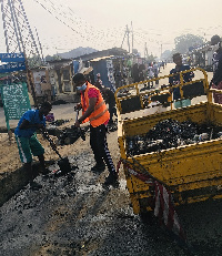 Alajo North Assembly Member, Ibrahim Halidu with a colleague doing the cleanup