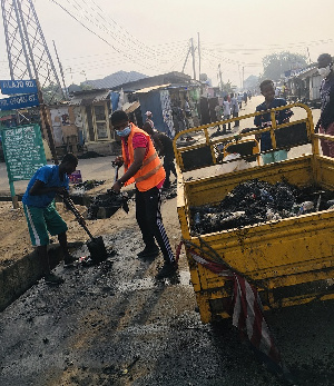 Alajo North Assembly Member, Ibrahim Halidu with a colleague doing the cleanup