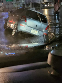 A car stuck in a gutter fue to flooding