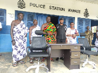 Chief of Ankaako, Nana Obeng Nuakoh II (middle) with his entourage and a police