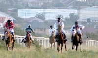 Some horse racers in a competition