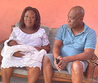 Daniel Naawu and his wife Audrey Agyapong with one of the twins