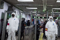 Security personnel wearing protective clothing to help stop the spread of a deadly virus