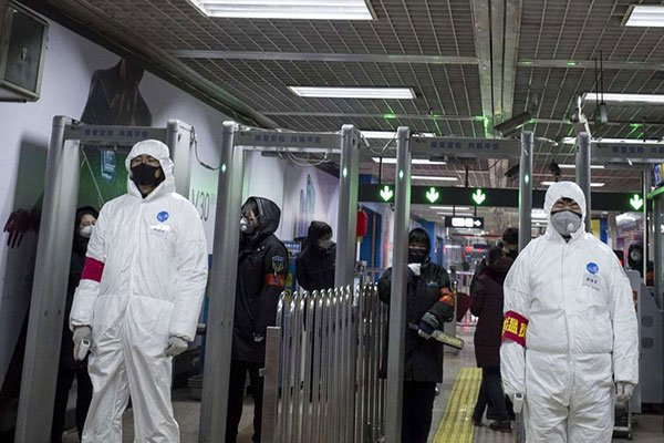 Security personnel wearing protective clothing to help stop the spread of a deadly virus