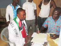 Mr Cyril Tetteh Laryea (left) receives nomination form from party official