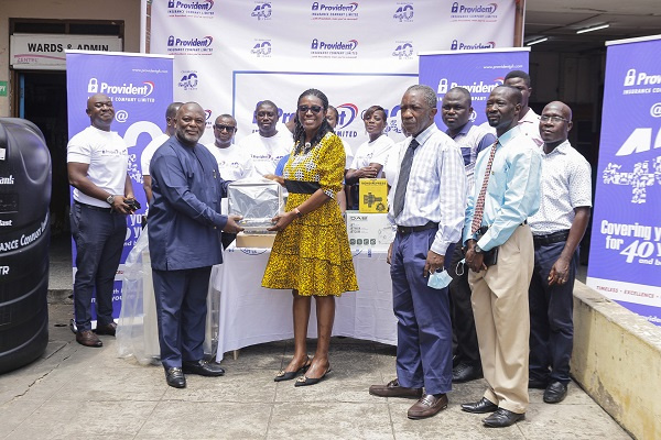 Michael Ashong, the CEO of Provident Insurance handing over the items to Dr. Maame Yaa Nyarko