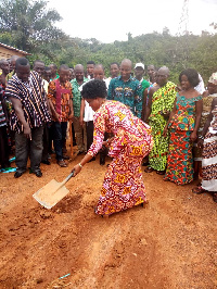 Faustina Amissah cutting sod for the construction of an ultramodern clinic