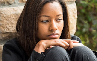 Sad young afro caribbean woman looking at the camera