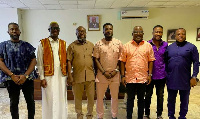 Asamoah Gyan (middle) with his team and officials of the NSA