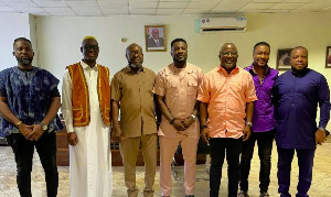 Asamoah Gyan (middle) with his team and officials of the NSA