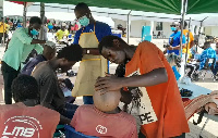 Some members of the public receiving a haircut