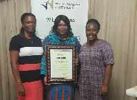 Brigitte Therson-Cofie (middle) holding her citation