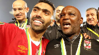 Al Ahly head coach Pitso Mosimane celebrating with a player