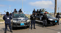 Security forces stand guard during the 9th anniversary of revolution against late Muammar Gaddafi