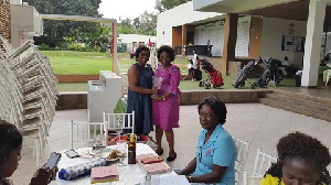 Madam Peace Akwei (L) receiving her prize from Esther Amedzro, GLGU president