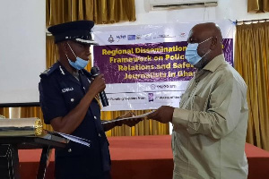 DCOP Mr Atibilla receiving a copy of the Framework document from Prof Karikari