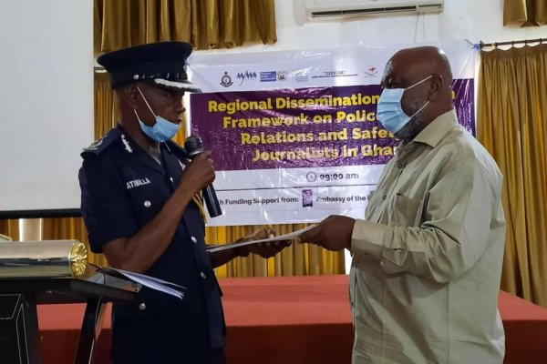 DCOP Mr Atibilla receiving a copy of the Framework document from Prof Karikari