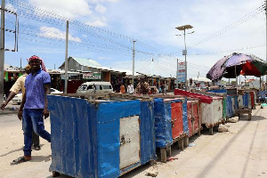 Residents walk past closed khat stimulants stalls, amid concerns about the spread of coronavirus dis